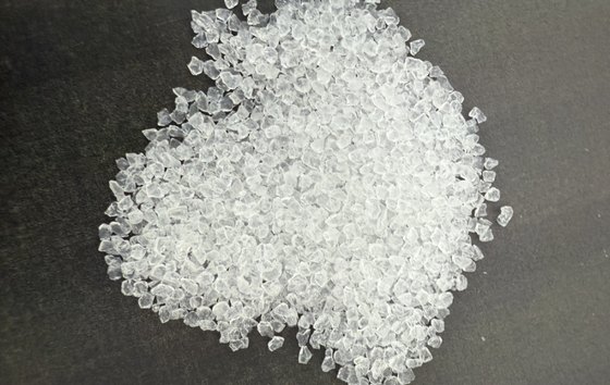 White translucent metasilicate filter granules on a dark surface (media supplier's photo)