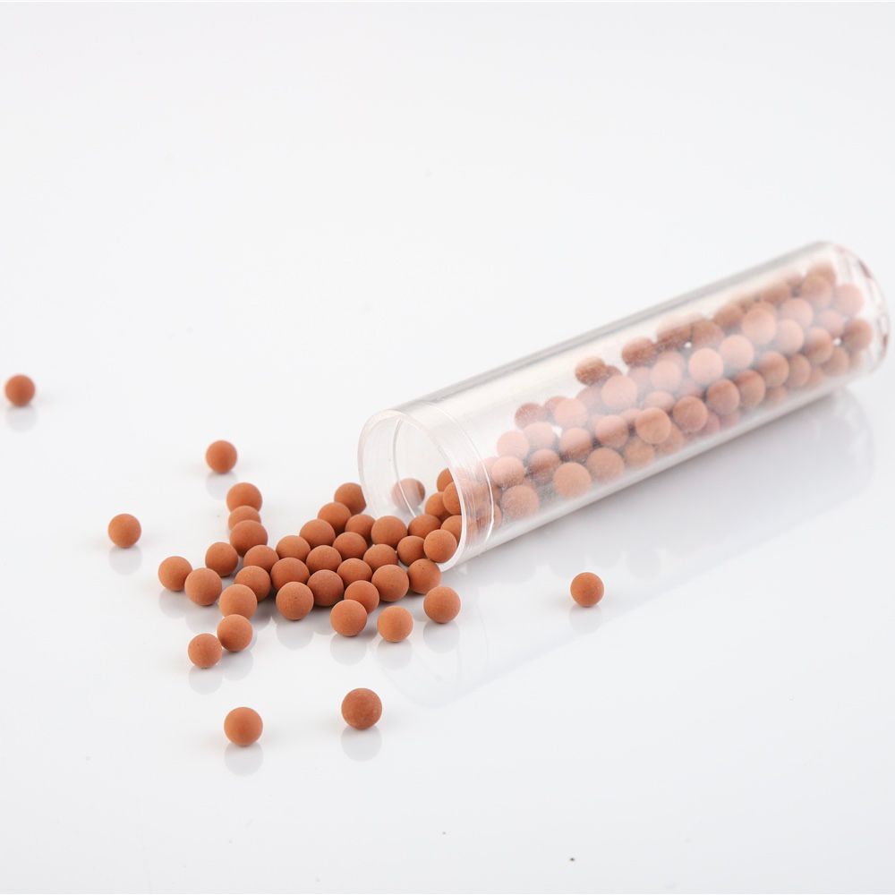 Mineral Stone Beads Filter terracotta-orange mineral beads spilling from a clear refill tube